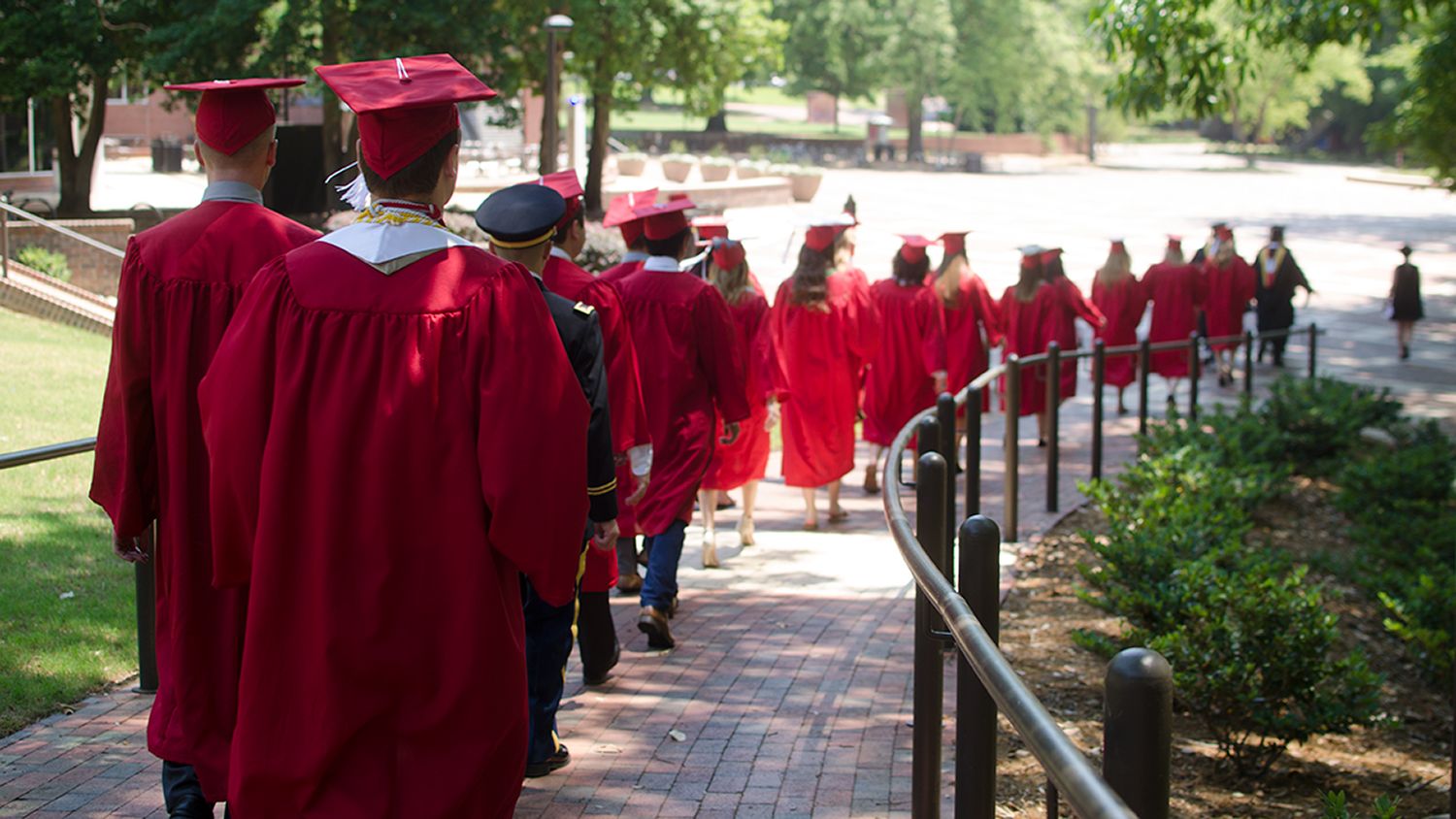 Spring 2018 graduates walking down brickyard ramp