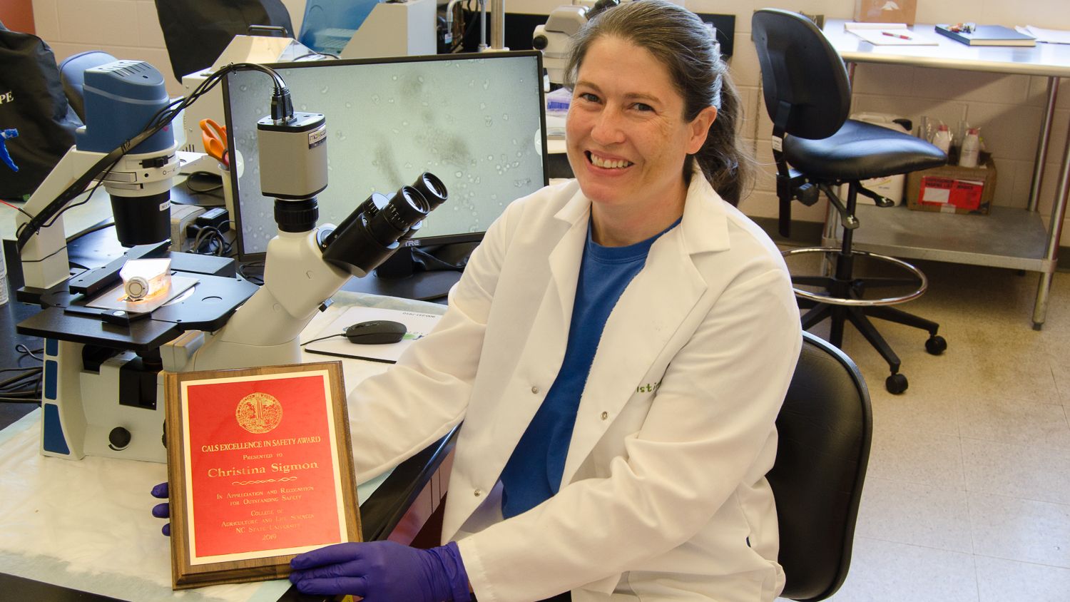 Christina Sigmon in her lab with her safety award plaque