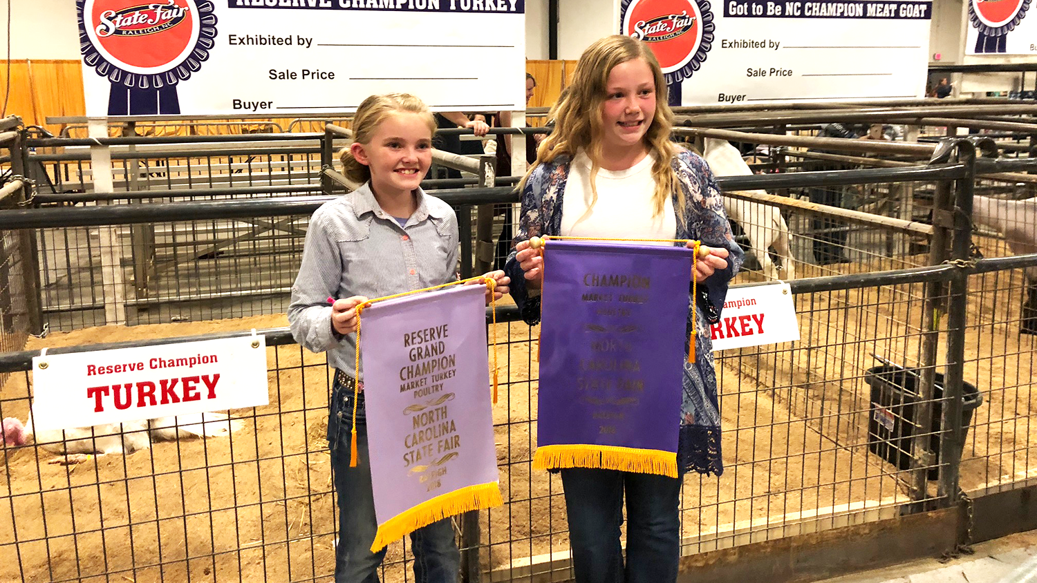 Caroline Scarlett and Laura Jessup holding champion banners