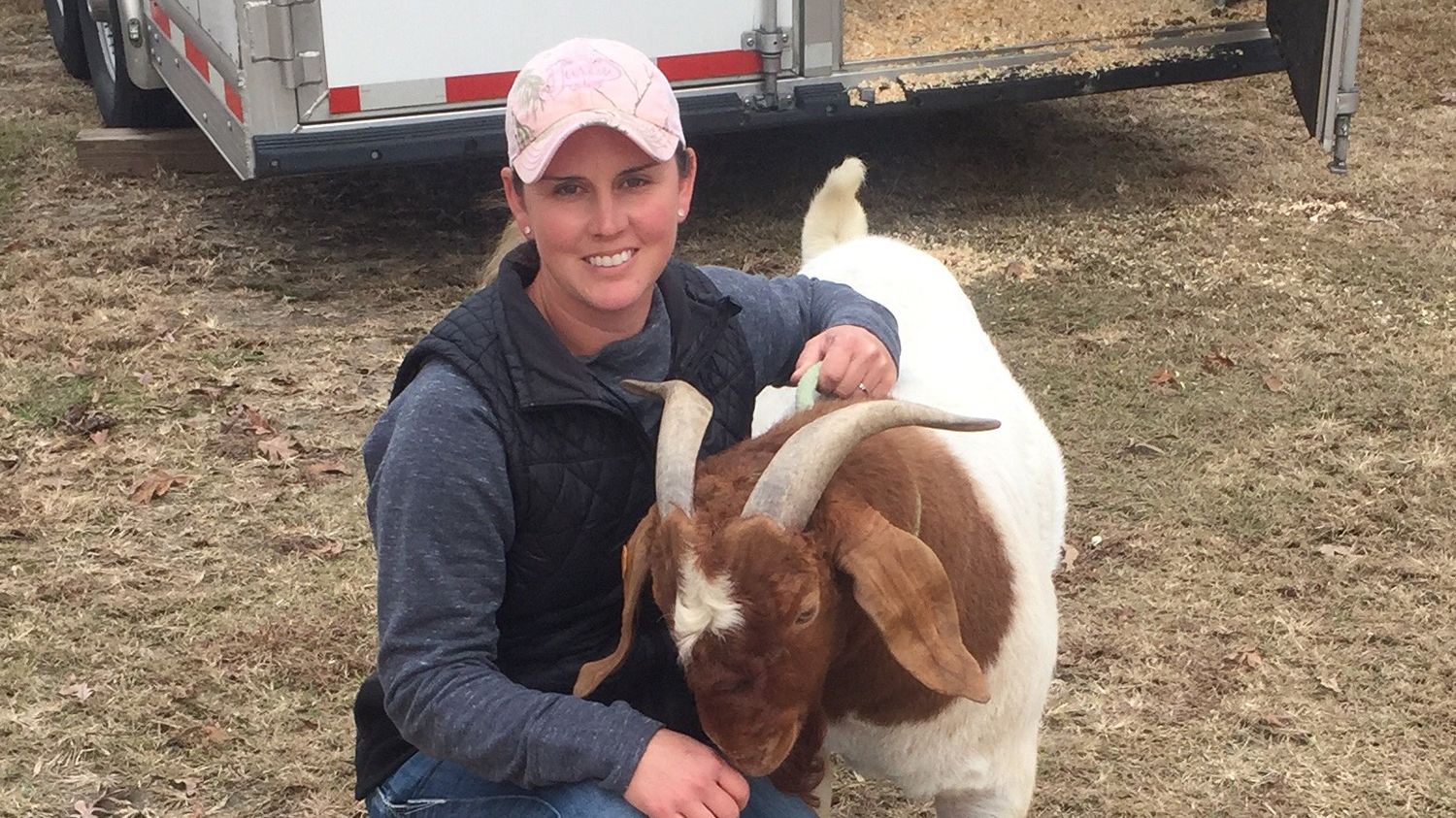 Jennifer Harrison with a horned brown and and white goat