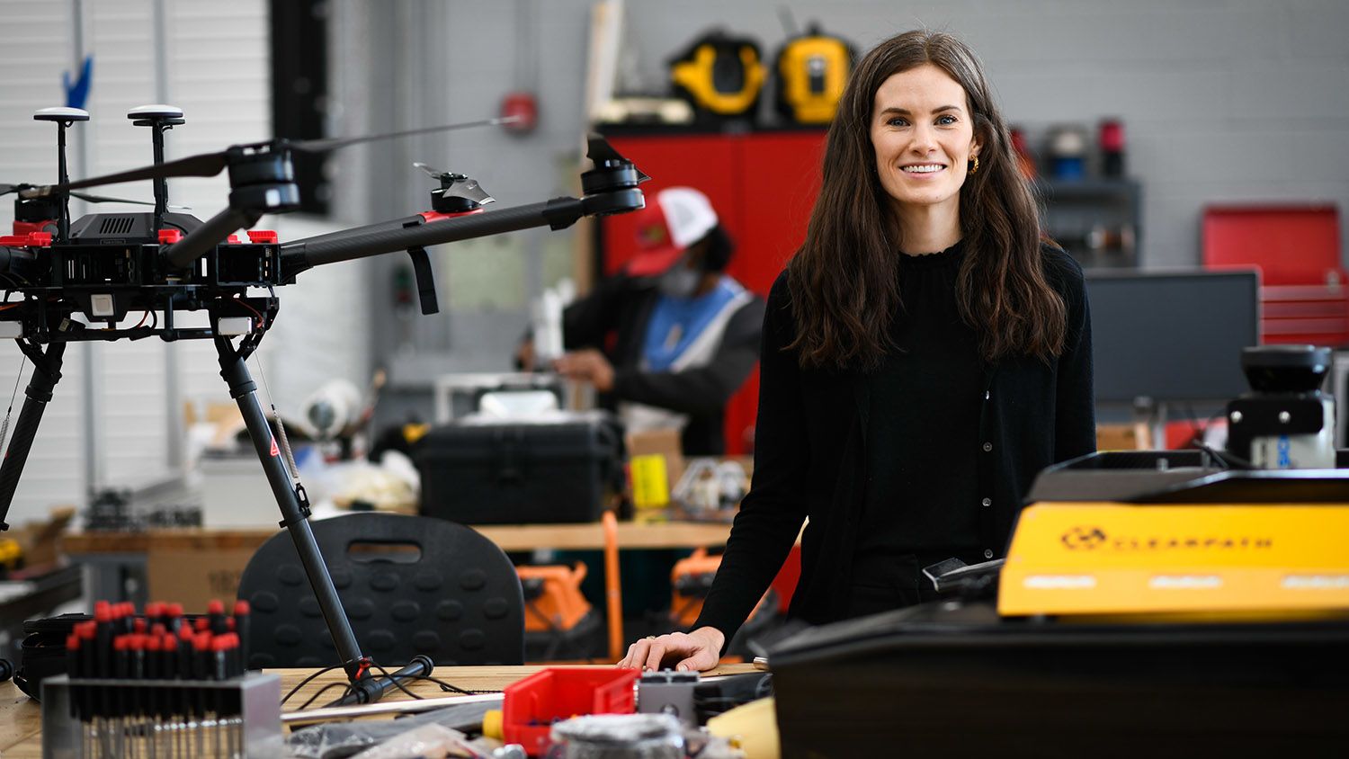 Woman with drones and robots.