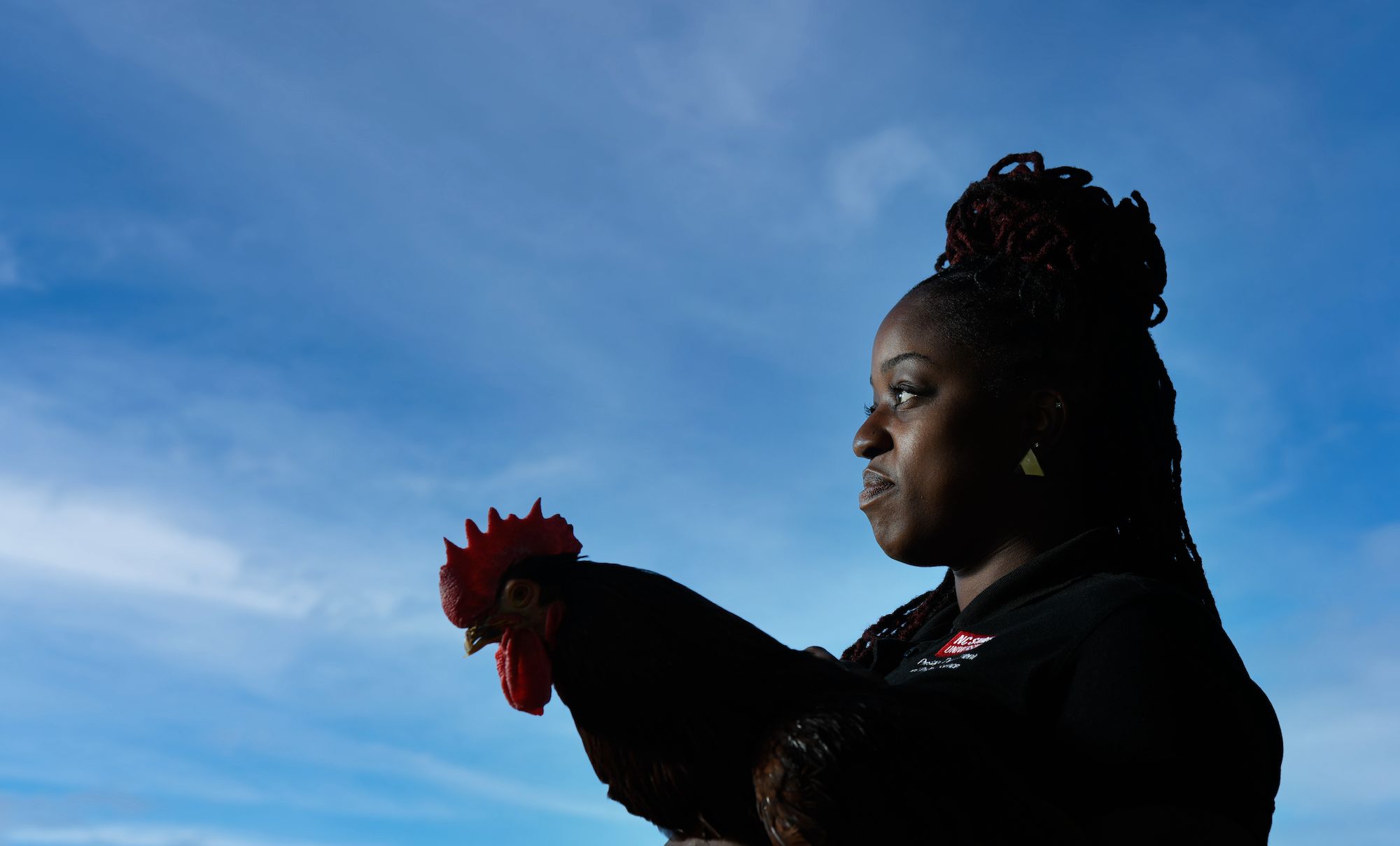 Poultry Science PHD Graduate, Dannica Walls, with her a gaze on a flower in her hands