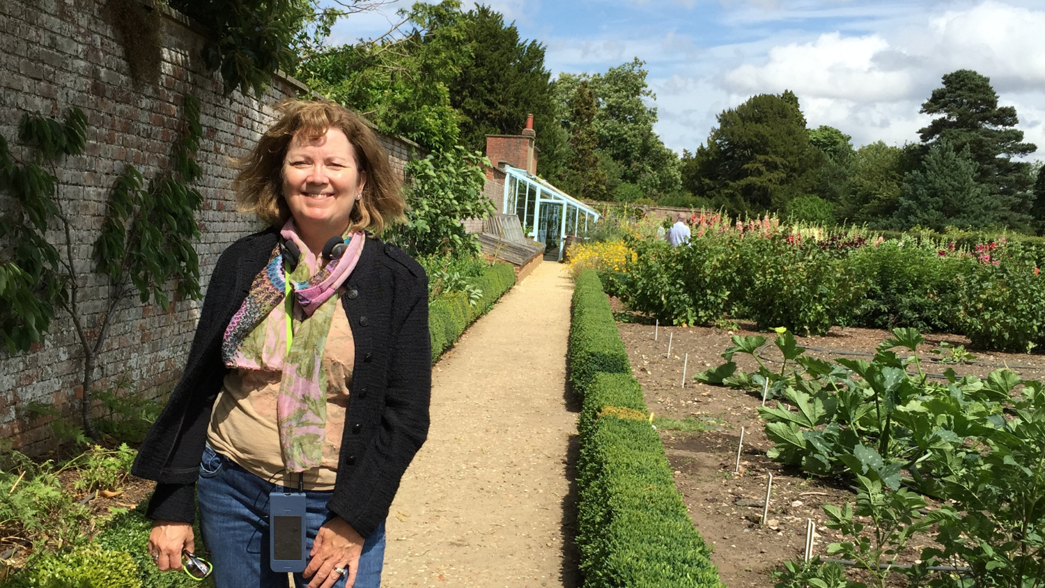 Dr. Jean Ristaino stands next to potato plots in the backyard of Down House, Charles Darwin’s home.