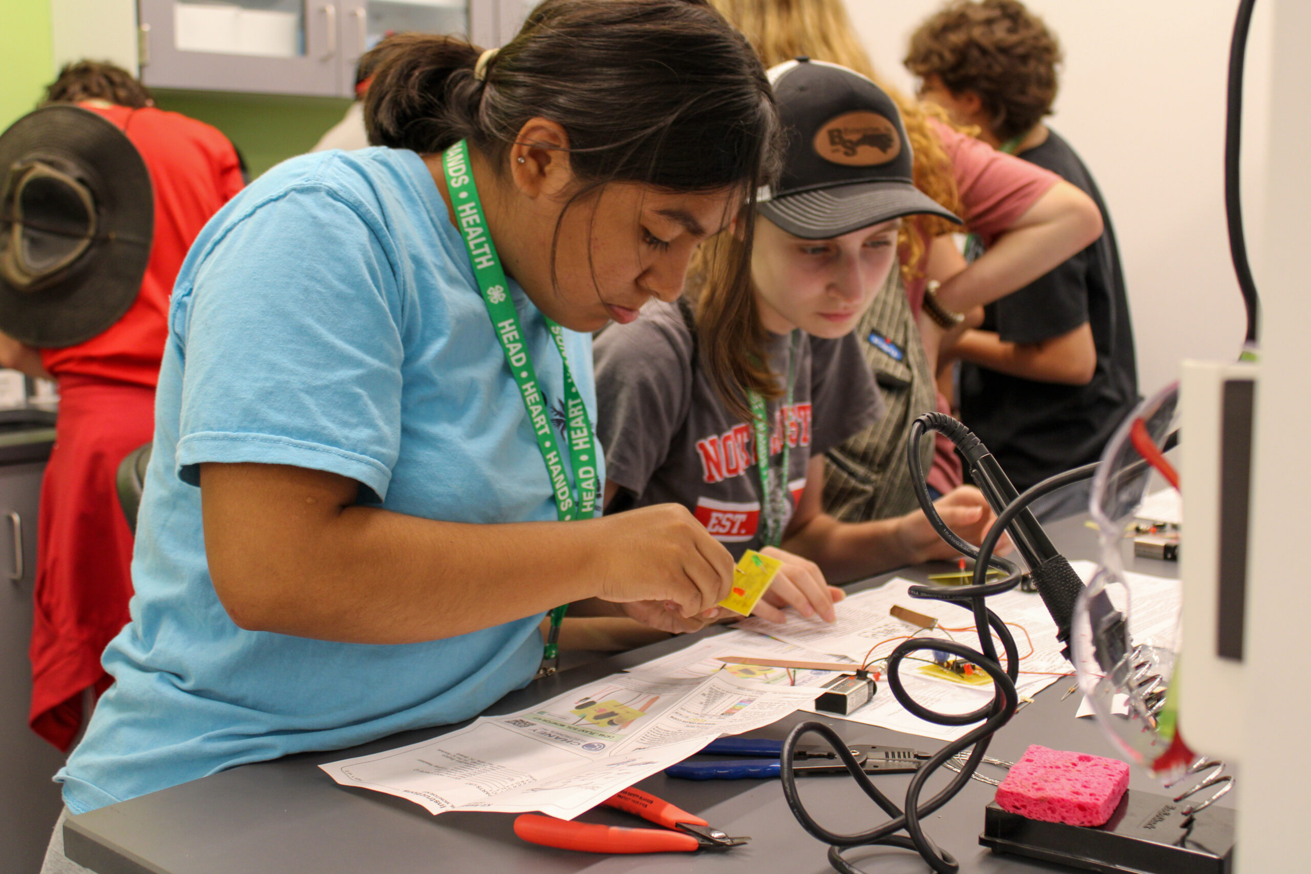 High school students from the Horticultural Science Summer Institute learn to make soil sensors in the N.C. PSI Demo Lab.