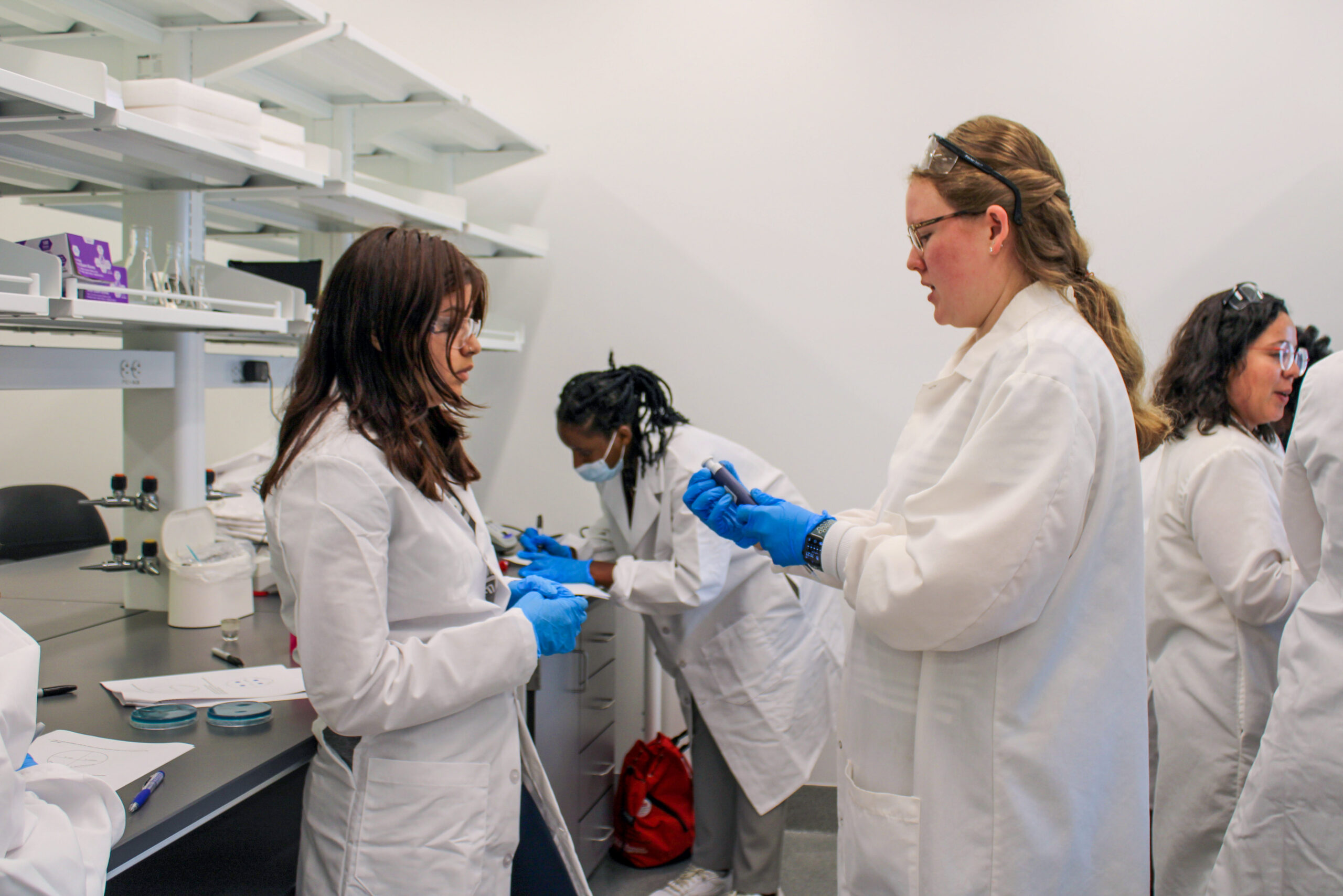 N.C. PSI graduate students teach high school students how to perform experiments in the Demo Lab.