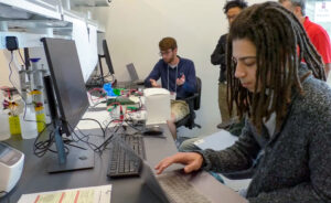Students participating in the N.C. PSI Hack-a-ton working in the Demo Lab.