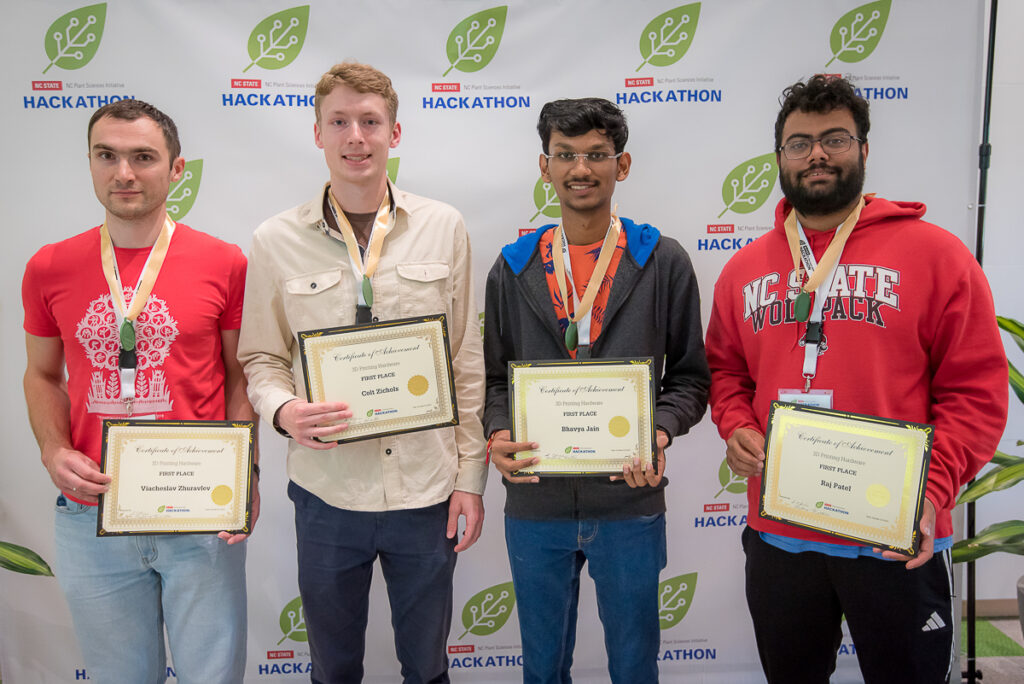 NC PSI Hackathon participants holding their first place awards