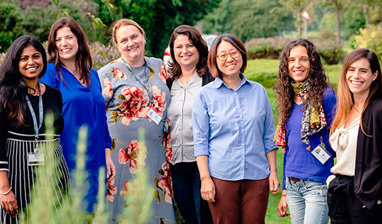 seven women standing in a field