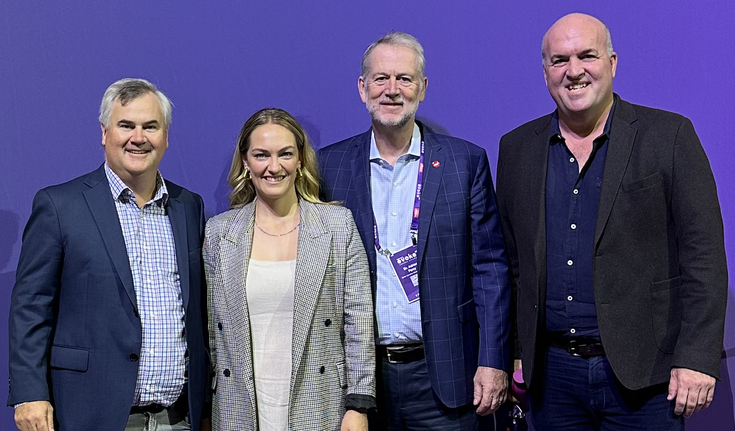 Four professionals standing side-by-side