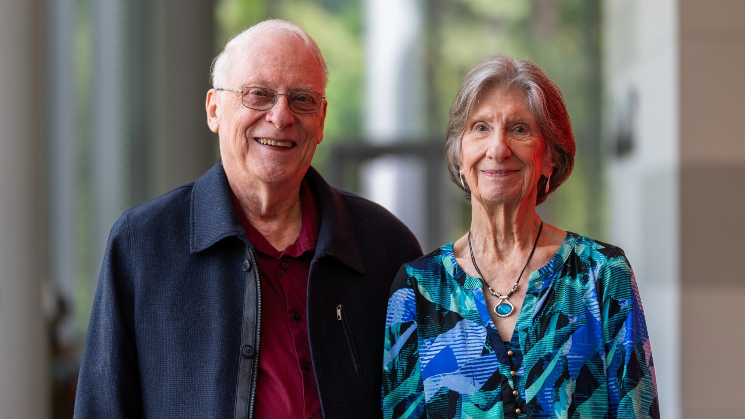 Two people smiling as they pose