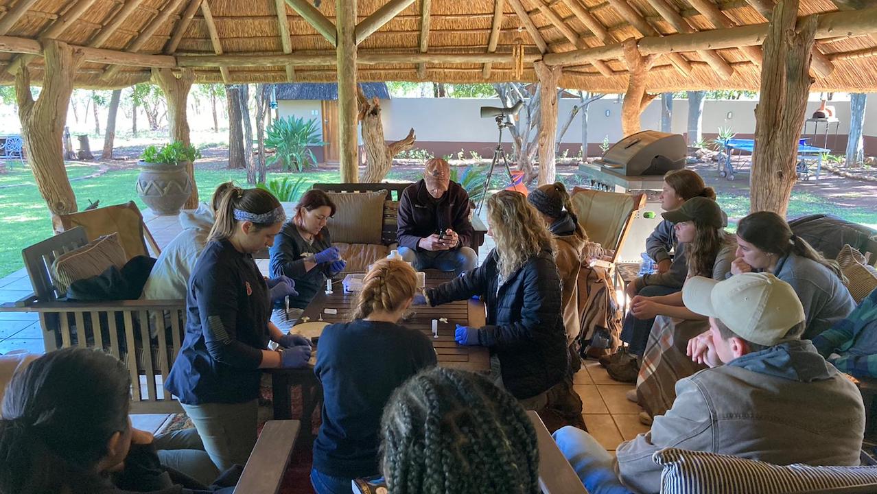 group of students around a table in south africa