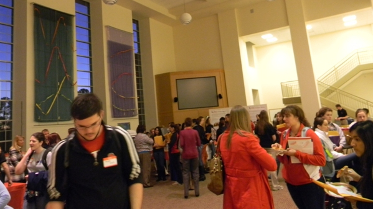 Students around posters in Riddick Hall