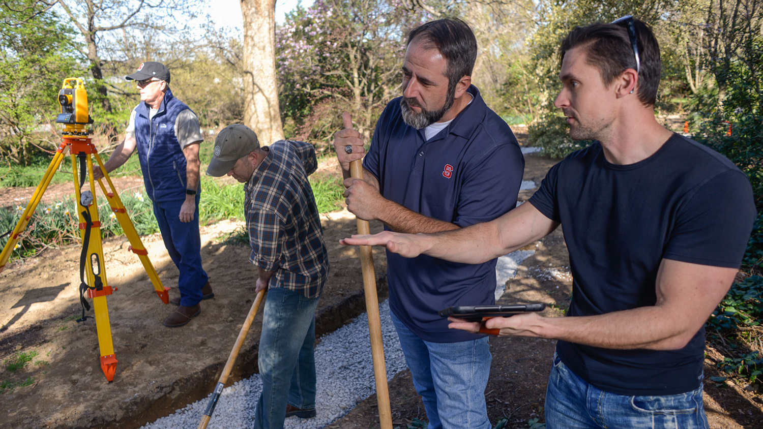 Robert Elliot working on a construction project with three others.