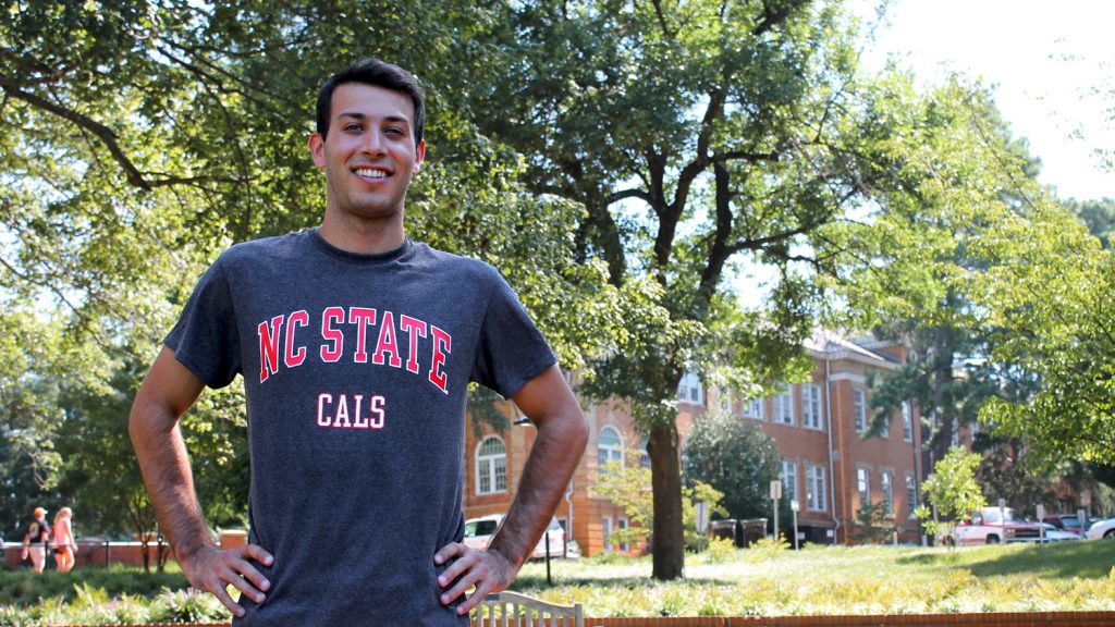 Olympic diver and Physiology Program graduate student Nick McCrory in front of Patterson Hall on NC State's campus.