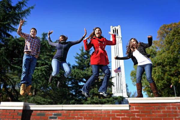 Students in front of the belltower at the entrance to NC State on Hillsborough Street. Photo by Marc Hall