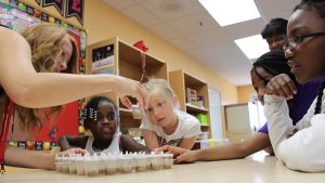 Patty Alder (left) shows insects to day campers at Fort Bragg.