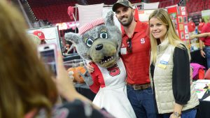Mascot with woman and man