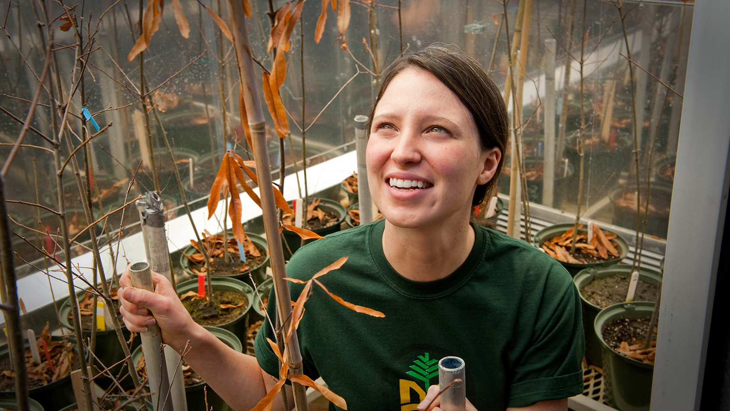 Emily Meineke in a campus greenhouse.