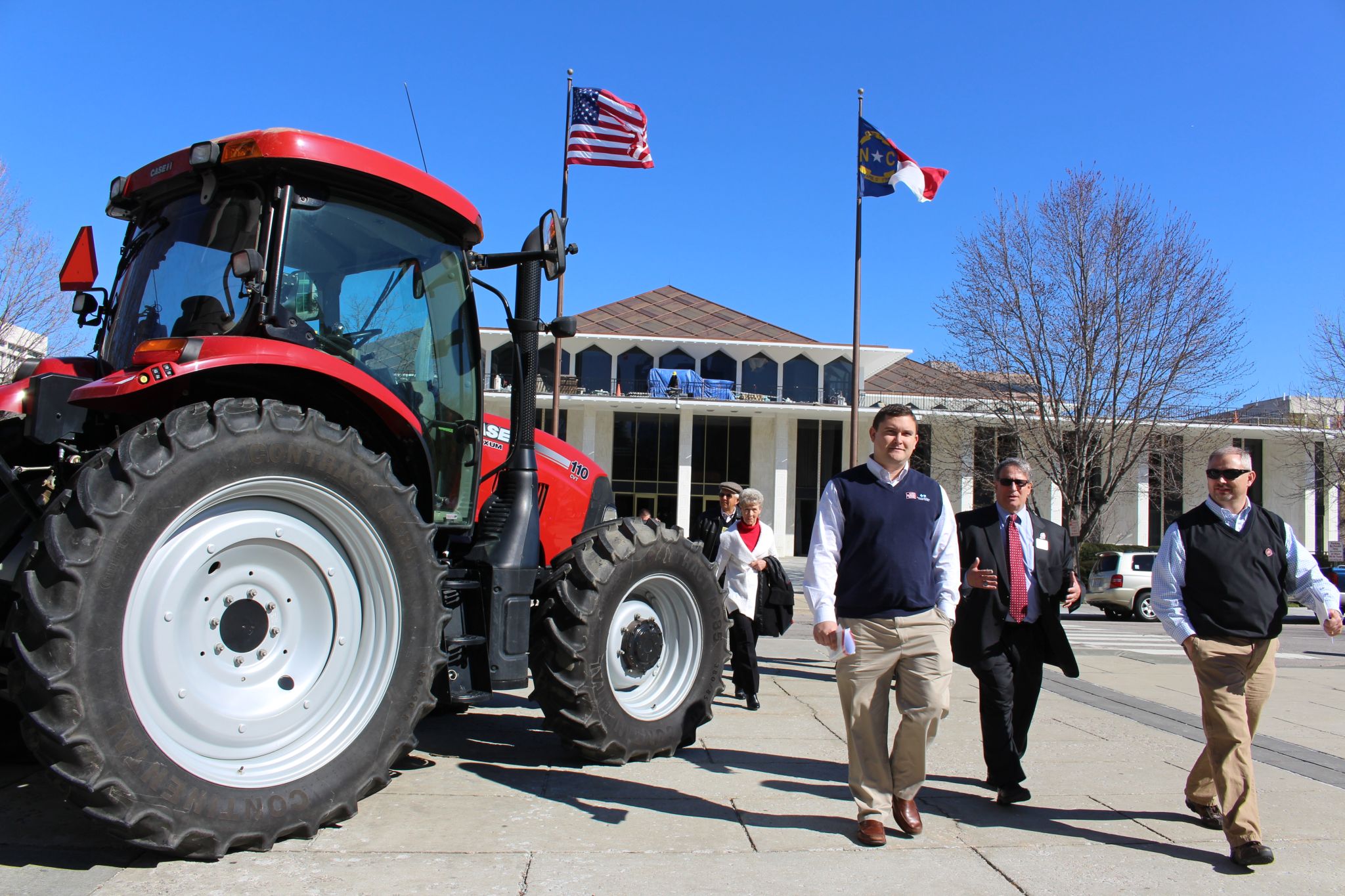 Tractor and people in front of North Carolina legislative building.