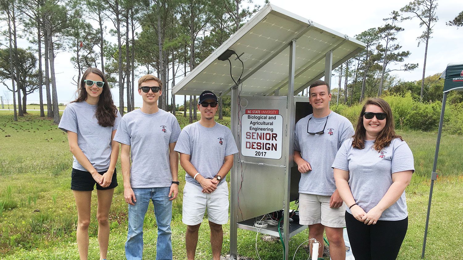 BAE senior design students with the solar-powered pump they built and installed on Harkers Island