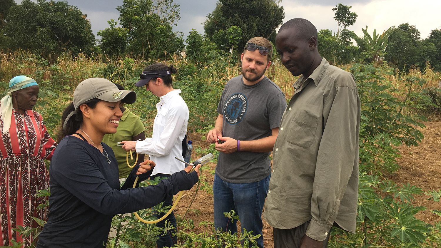 Gabriella Chavez (left) and William Sharpee (middle) talk with local cassava growers about how Cassava Mosaic Disease is transmitted.