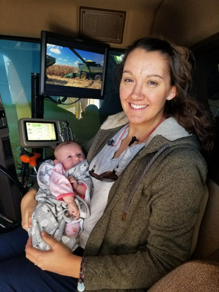 NC State Extension Agent Andrea and AdaMae Gibbs, her newborn daughter, in the AgriPride Simulator in March 2018.