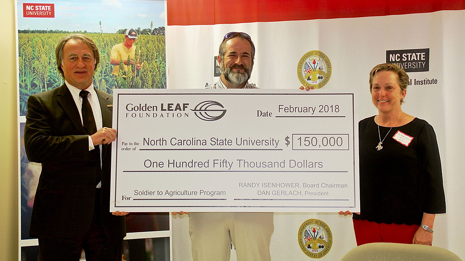 Mark Sorrells (left) of Golden LEAF presents a check to Robert Elliott and Beth Wilson for the Soldier to Agriculture program.