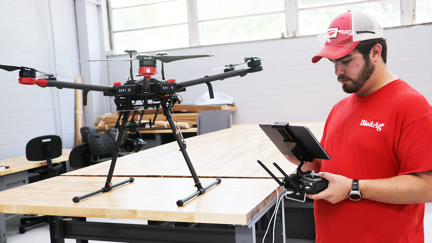 Student working with UAV technology in a lab