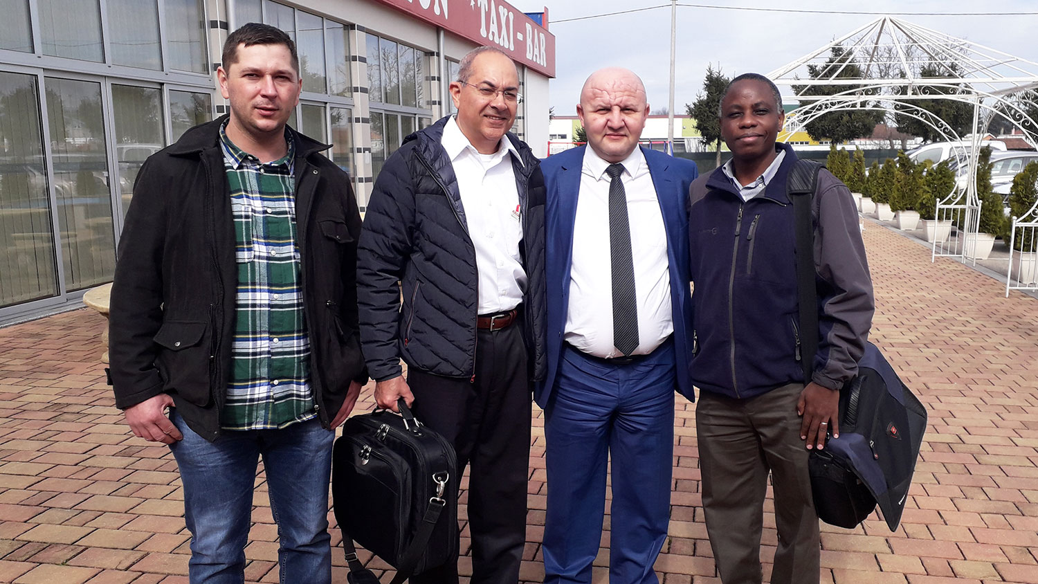 Photo of four men standing together