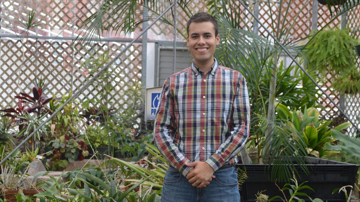 Student in NC State Conservatory (greenhouse)
