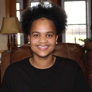 Head and shoulders photo of woman in black shirt