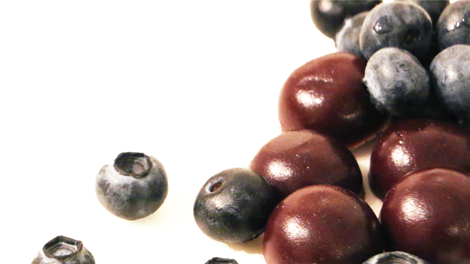 Close up of blueberries and blueberry gummies.