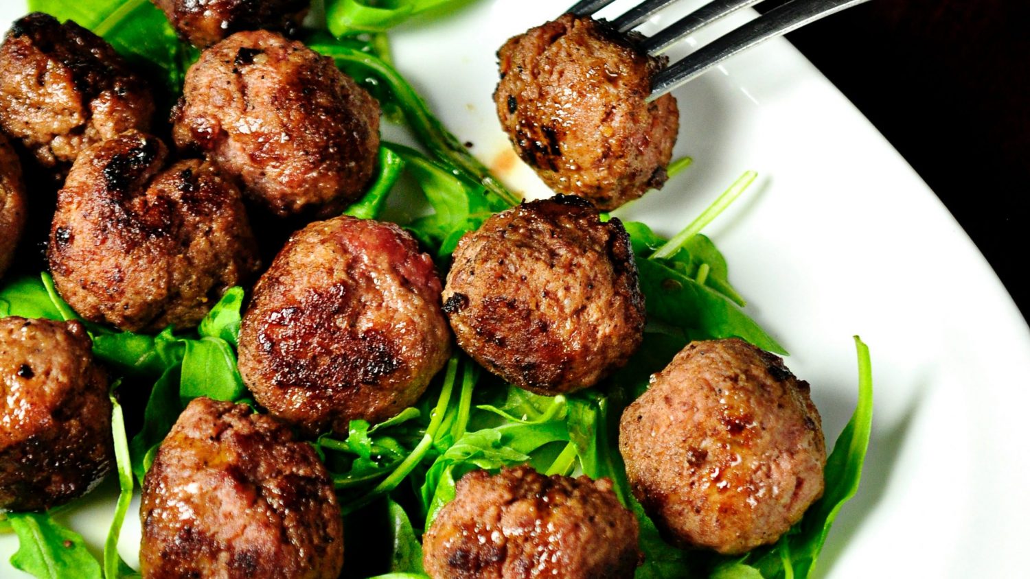 Meatballs and greens on a plate