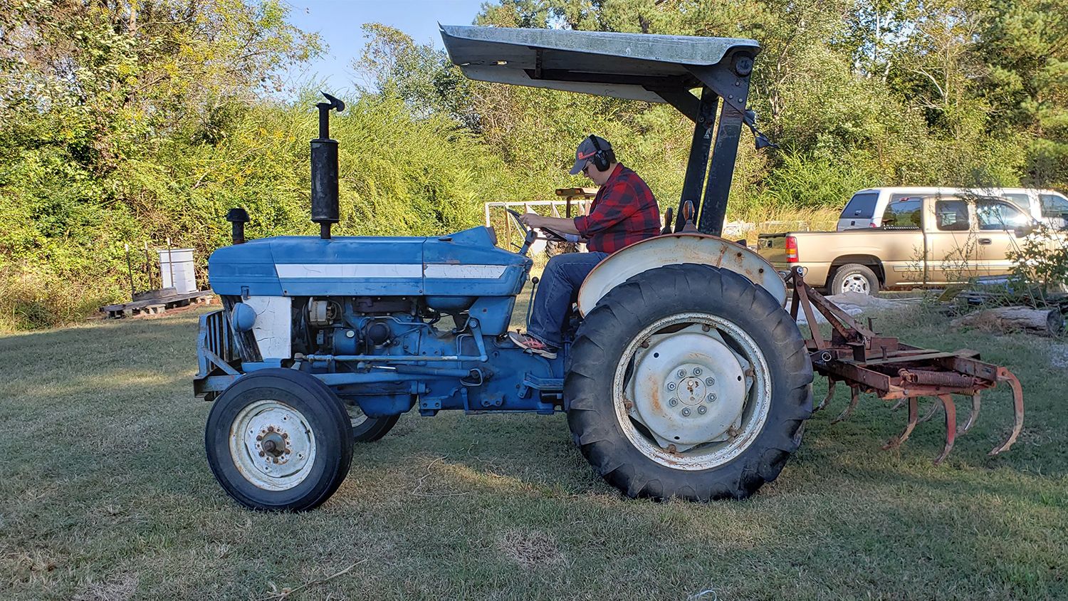 A woman on a large blue tractor.