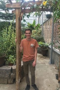 Young man in a greenhouse