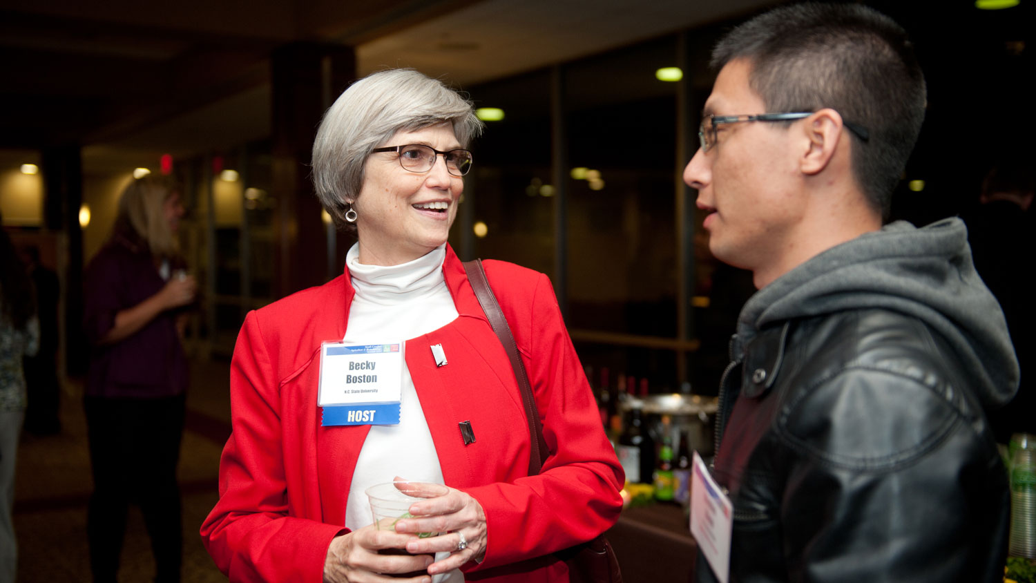 A woman and man conversing at a conference