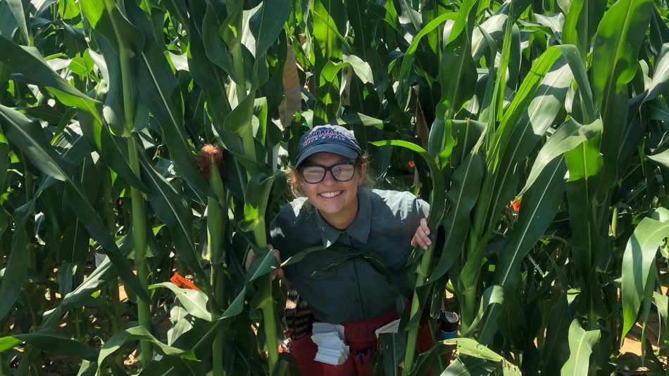 Woman smiling in field of corn.