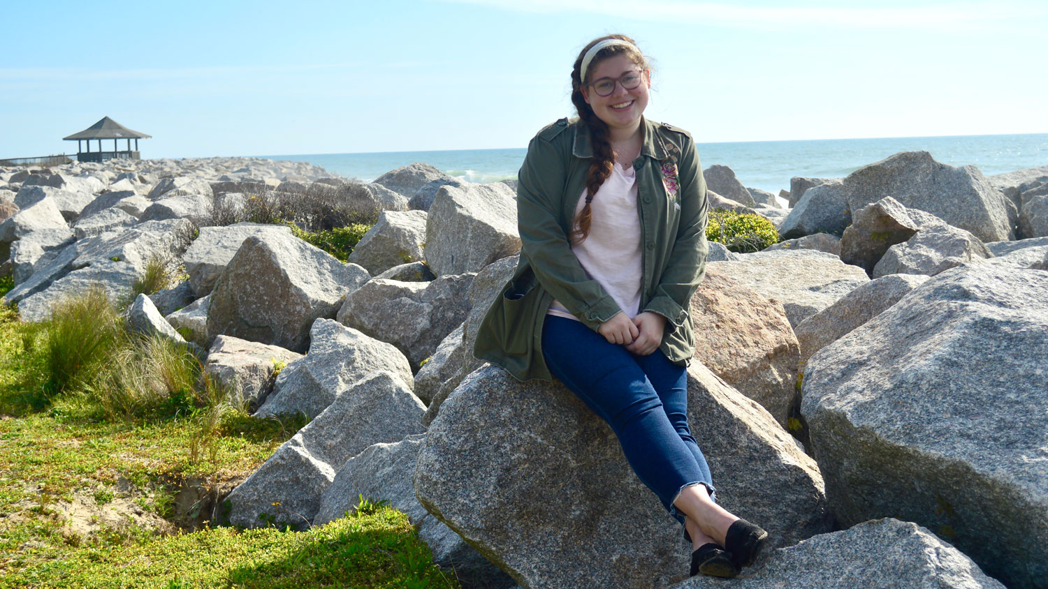 A young woman sitting on rocks