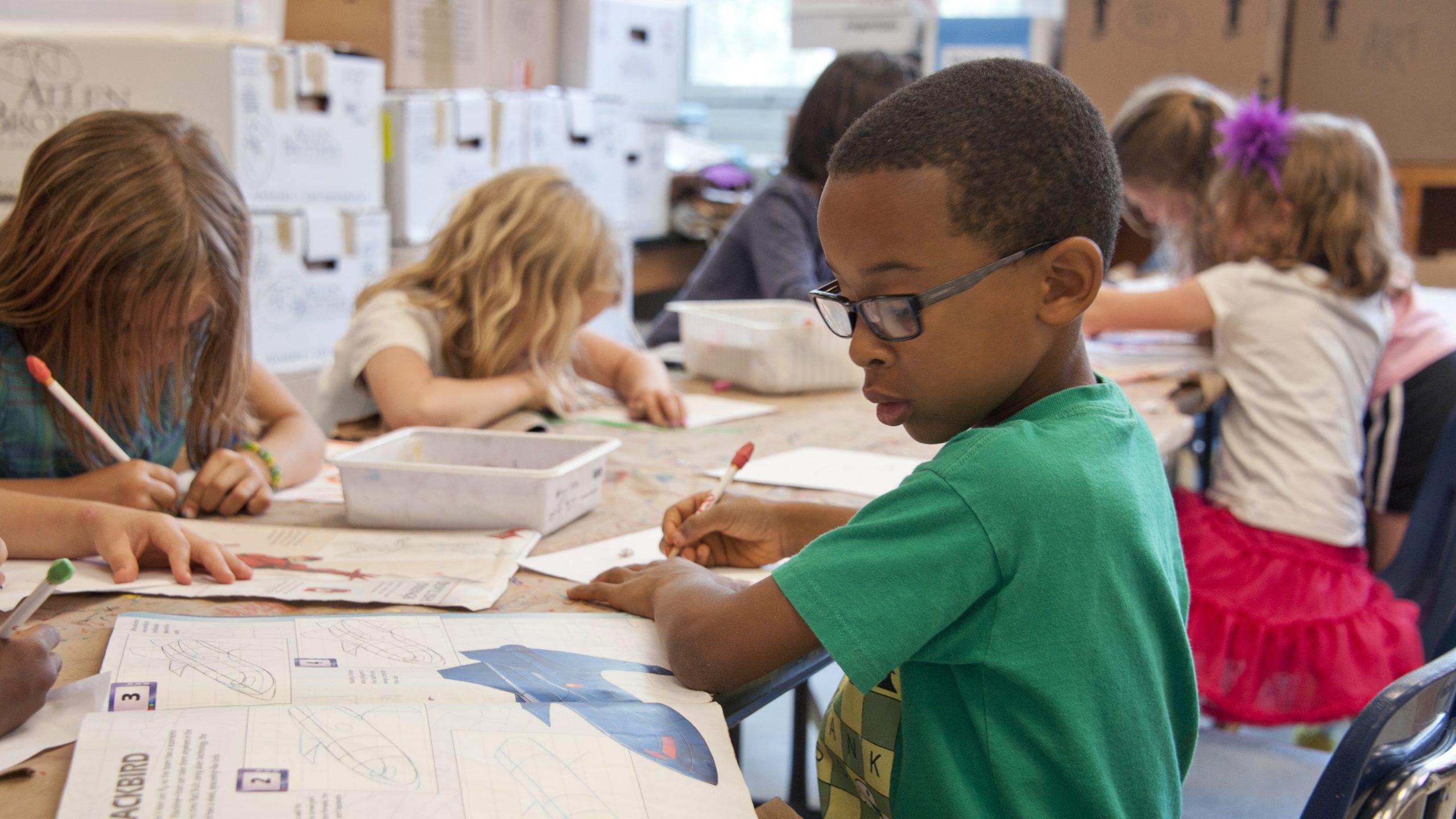 A young Black male student in a classroom