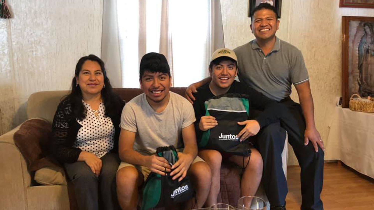 Students and family sitting on a couch.