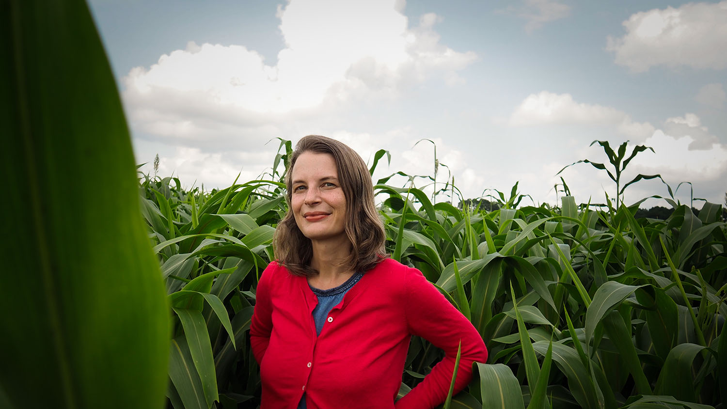 Hannah Burrack in front of a corn field.