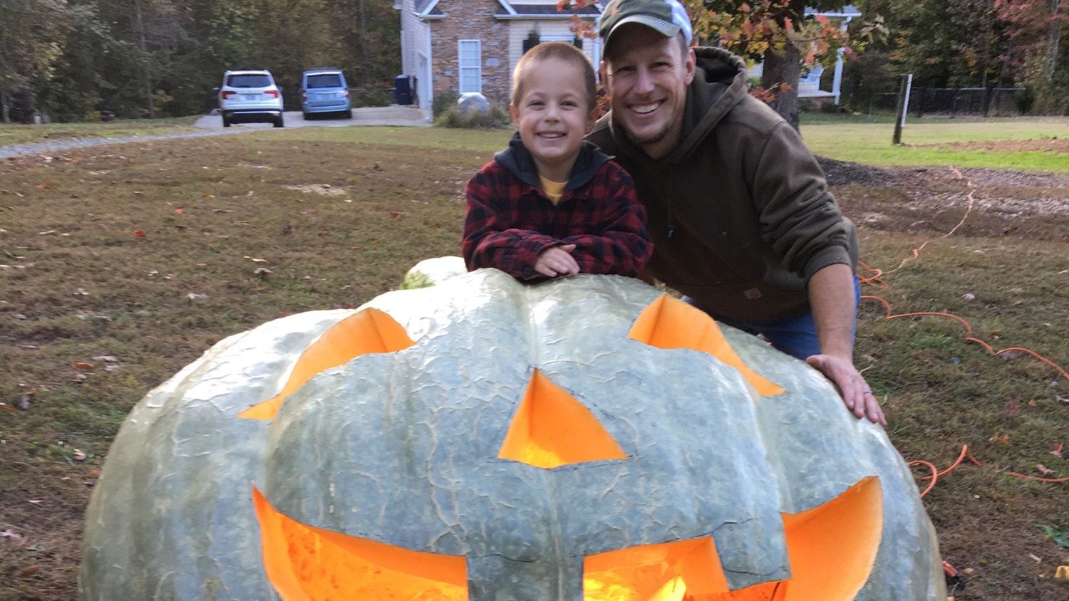 A child poses for photos next to the Pumpkin sculptures by