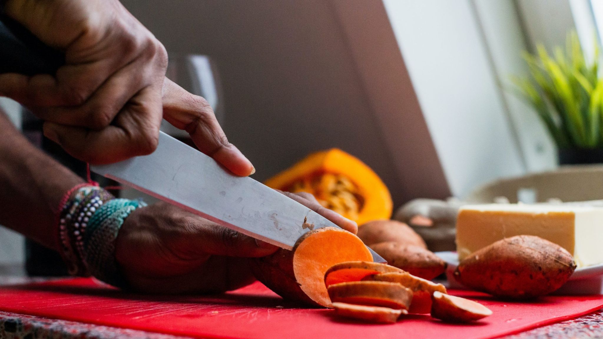 Hand slicing a sweetpotato
