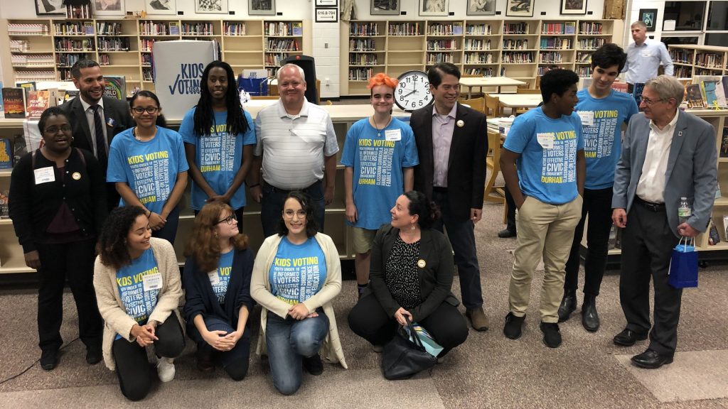 Group shot of diverse high school students in a school library.