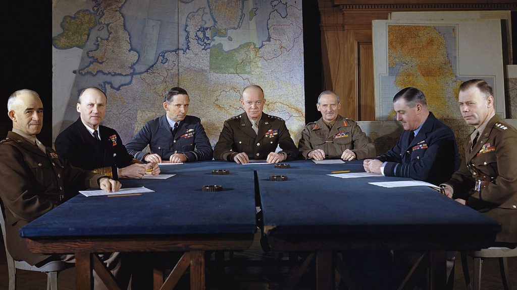 General Eisenhower and Allied leaders in front of military maps