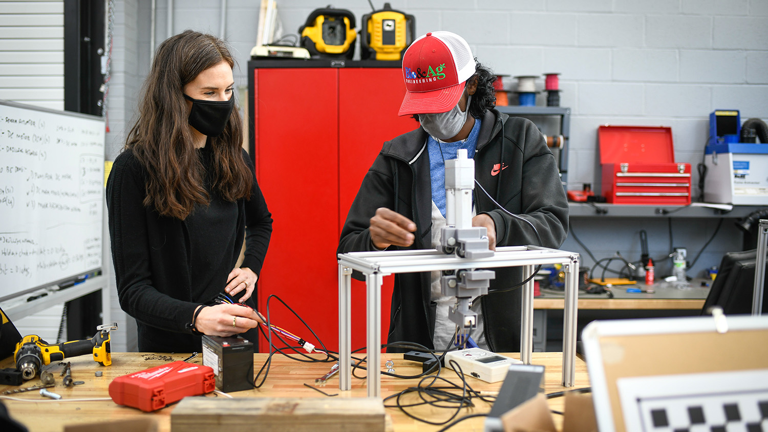 Two people working on an electronic device