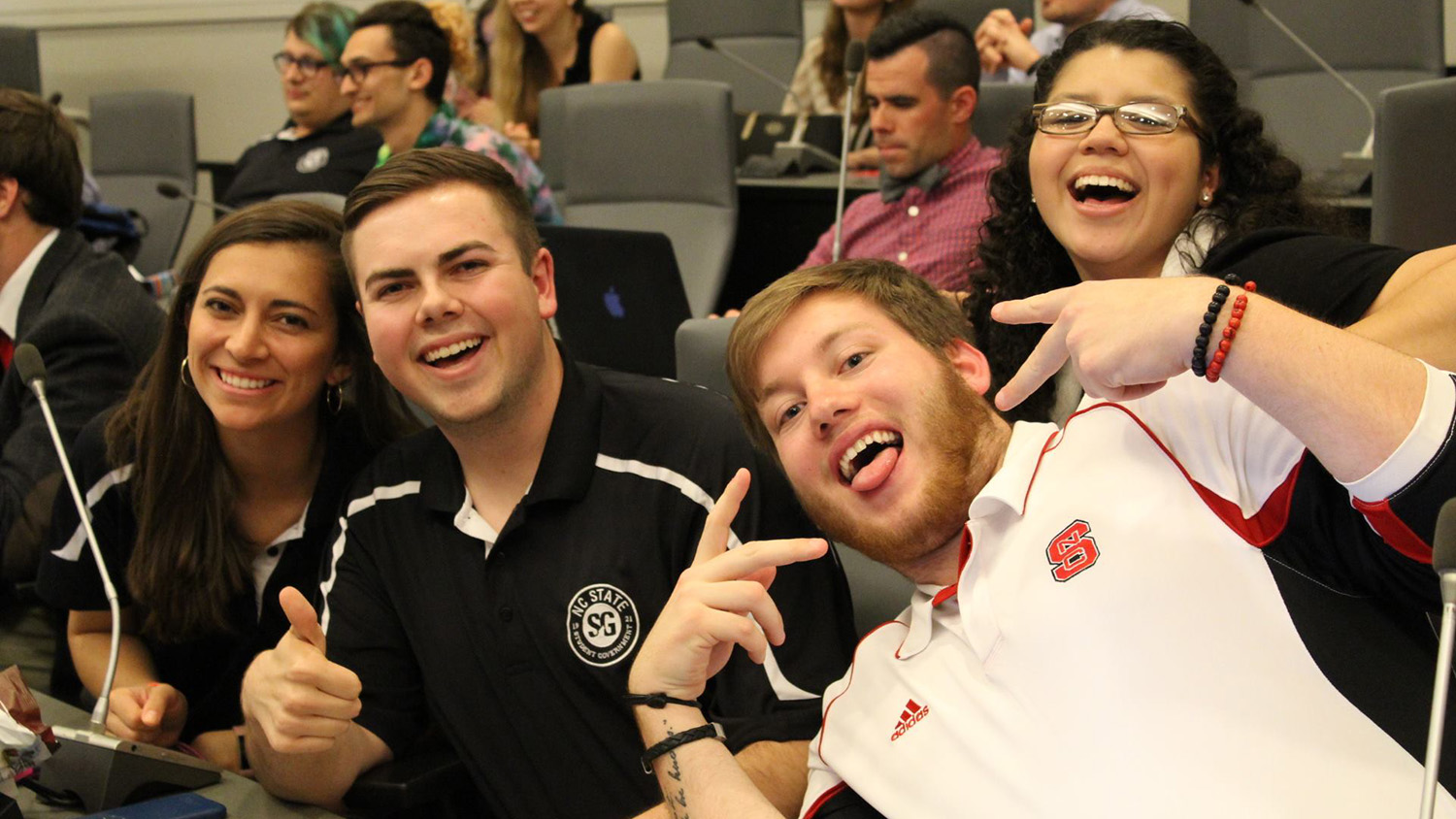 Students in a group smiling. 