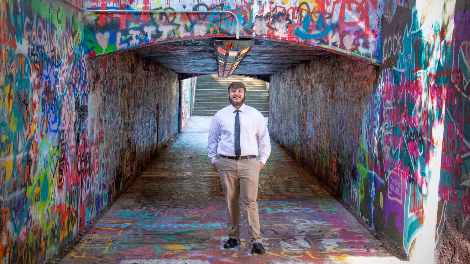 Ethan Thompson standing at the entryway of NC State's Free Expression tunnel.