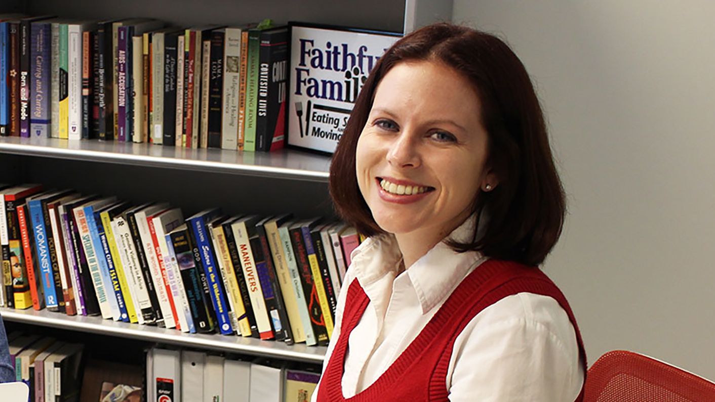 Woman beside bookshelves