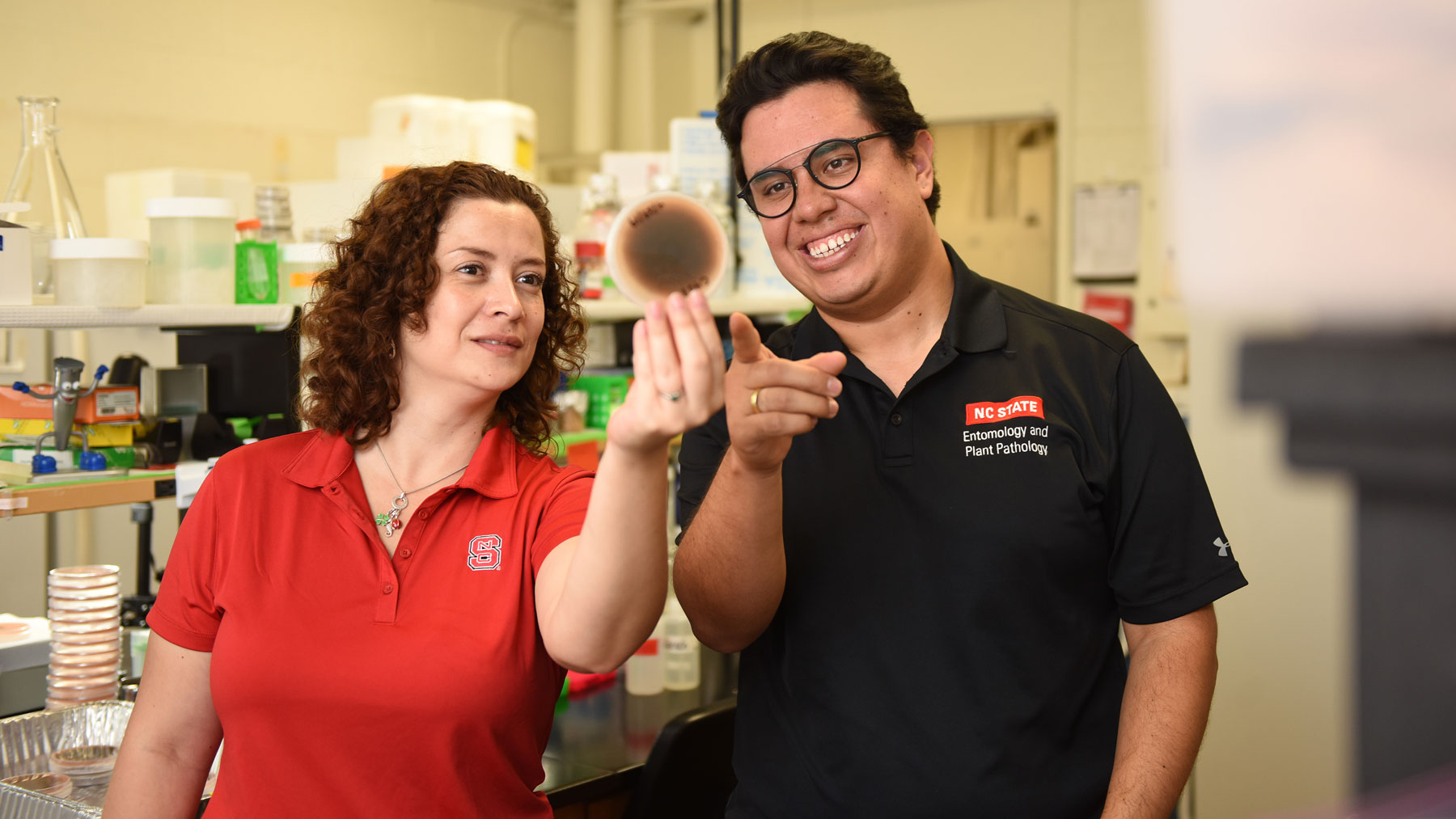 Lina Quesada and Camilo Parada examine a petri dish
